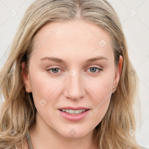 Joyful white young-adult female with long  brown hair and blue eyes