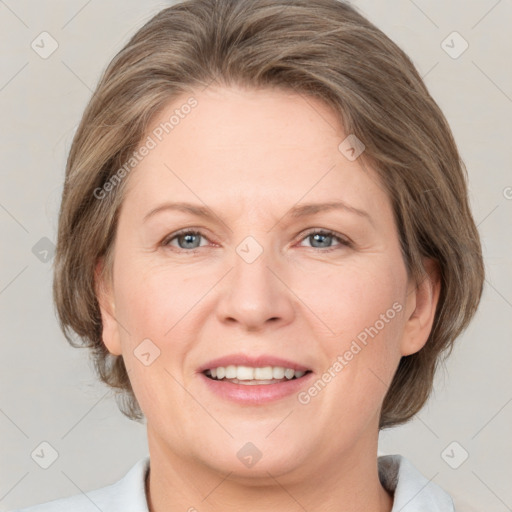 Joyful white adult female with medium  brown hair and grey eyes