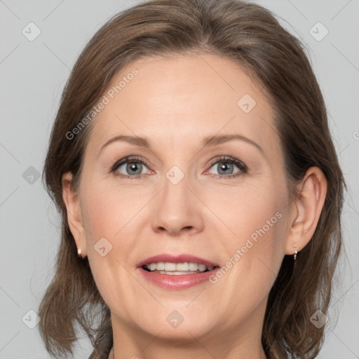 Joyful white adult female with medium  brown hair and grey eyes