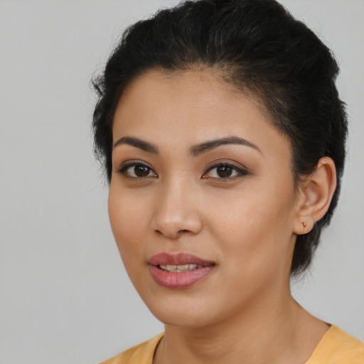 Joyful latino young-adult female with medium  black hair and brown eyes