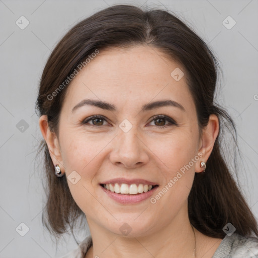 Joyful white young-adult female with medium  brown hair and brown eyes