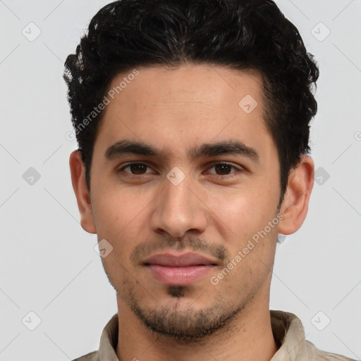 Joyful white young-adult male with short  black hair and brown eyes