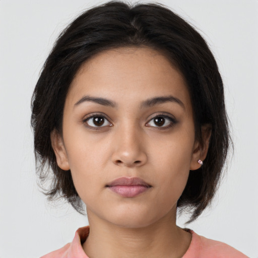 Neutral latino young-adult female with medium  brown hair and brown eyes