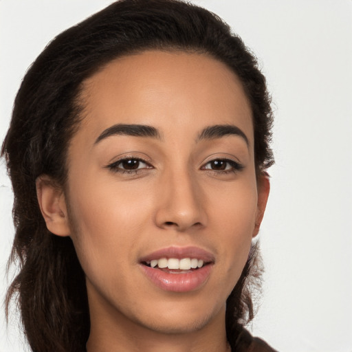 Joyful latino young-adult female with long  brown hair and brown eyes