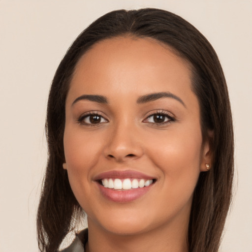 Joyful white young-adult female with long  brown hair and brown eyes