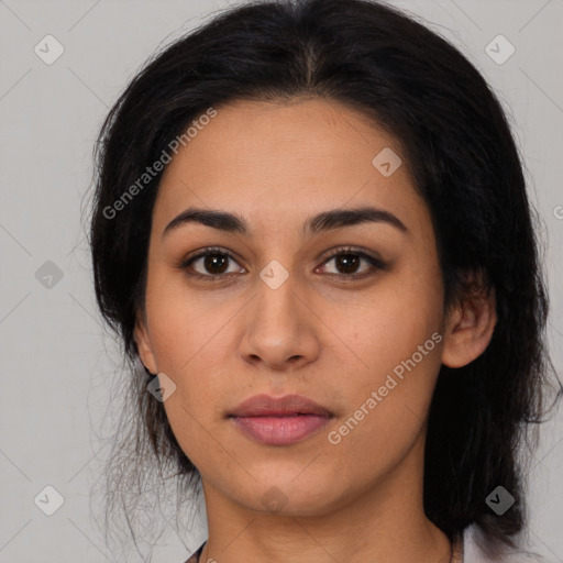 Joyful latino young-adult female with long  black hair and brown eyes