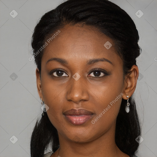 Joyful black young-adult female with long  black hair and brown eyes