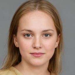 Joyful white young-adult female with medium  brown hair and blue eyes