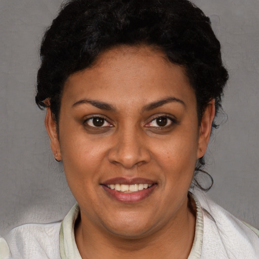 Joyful white young-adult female with short  black hair and brown eyes
