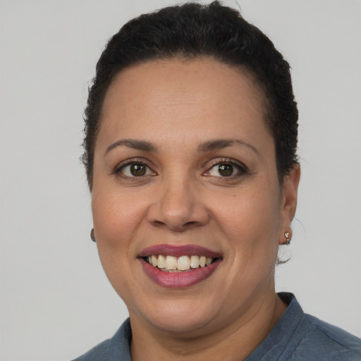 Joyful latino adult female with short  brown hair and brown eyes