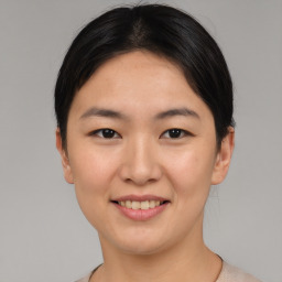 Joyful asian young-adult female with short  brown hair and brown eyes