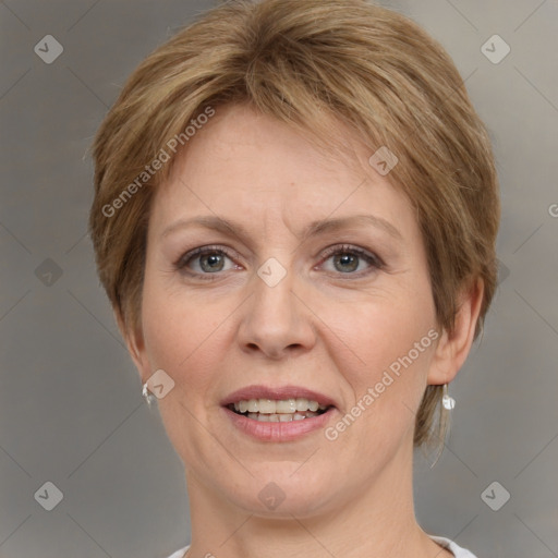 Joyful white adult female with short  brown hair and grey eyes