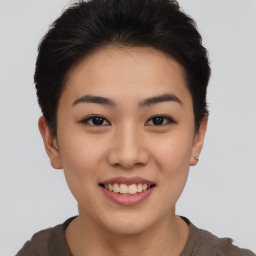 Joyful asian young-adult female with short  brown hair and brown eyes