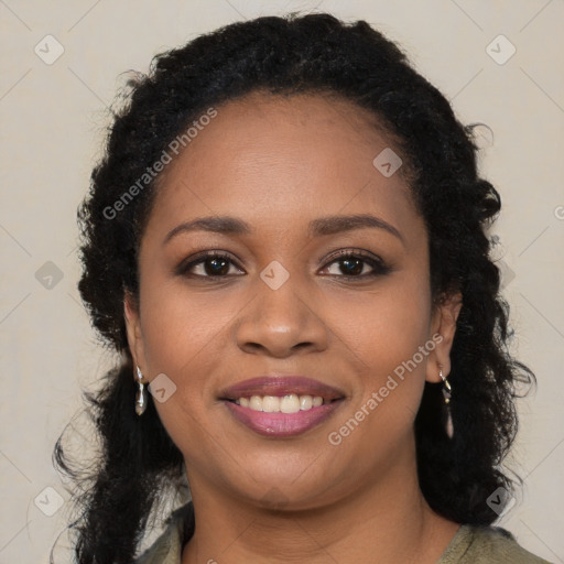 Joyful black young-adult female with long  brown hair and brown eyes