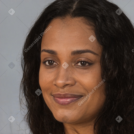 Joyful black adult female with long  brown hair and brown eyes