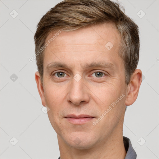 Joyful white adult male with short  brown hair and grey eyes