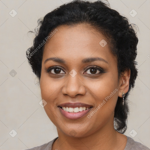 Joyful black young-adult female with medium  brown hair and brown eyes