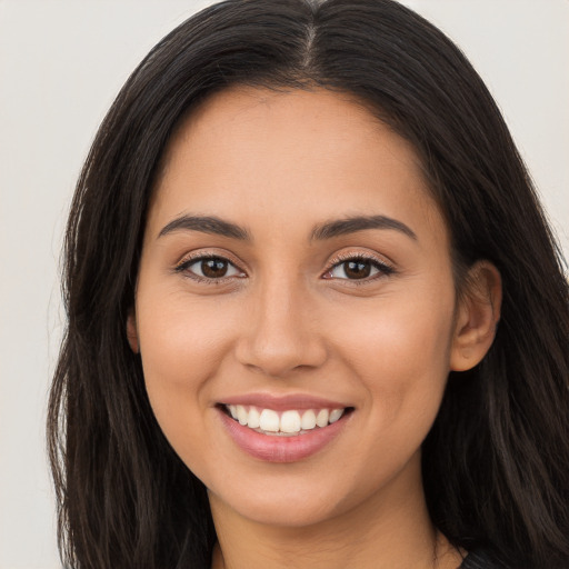 Joyful white young-adult female with long  brown hair and brown eyes