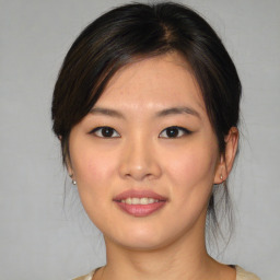 Joyful asian young-adult female with medium  brown hair and brown eyes