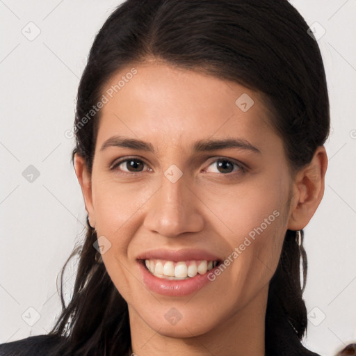 Joyful white young-adult female with long  brown hair and brown eyes