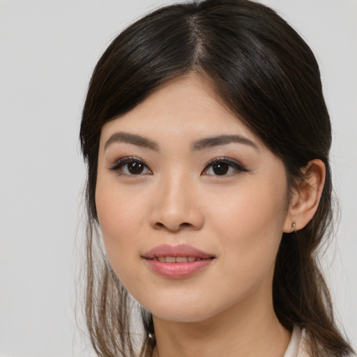 Joyful asian young-adult female with medium  brown hair and brown eyes