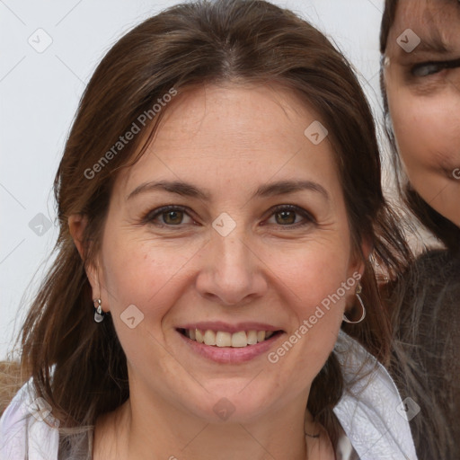 Joyful white adult female with medium  brown hair and brown eyes