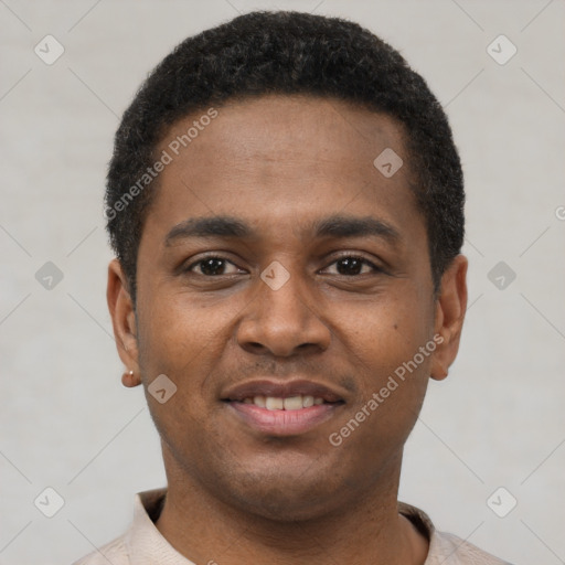 Joyful latino young-adult male with short  black hair and brown eyes