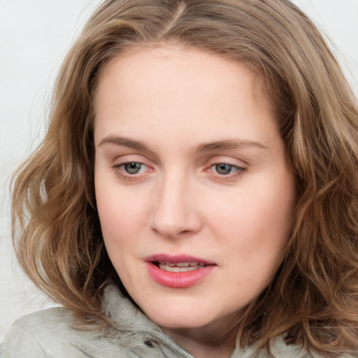 Joyful white young-adult female with medium  brown hair and green eyes