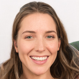 Joyful white young-adult female with long  brown hair and green eyes