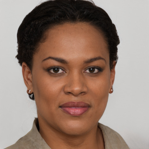 Joyful black young-adult female with short  brown hair and brown eyes