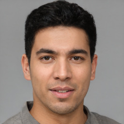 Joyful white young-adult male with short  black hair and brown eyes