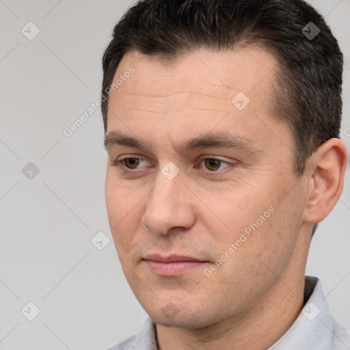 Joyful white adult male with short  brown hair and brown eyes