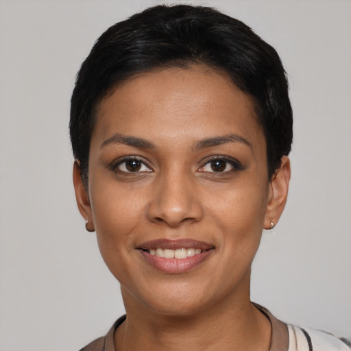 Joyful latino young-adult female with short  black hair and brown eyes