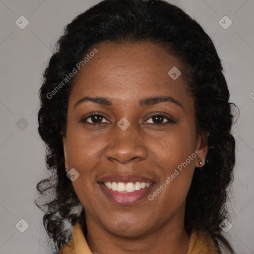 Joyful black adult female with medium  brown hair and brown eyes