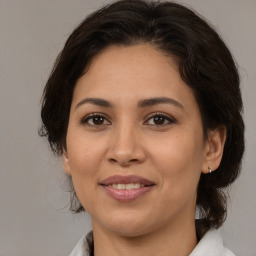 Joyful white adult female with medium  brown hair and brown eyes