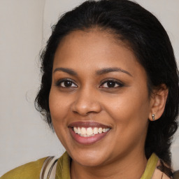 Joyful black young-adult female with medium  brown hair and brown eyes