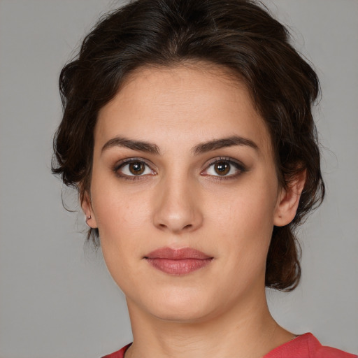 Joyful white young-adult female with medium  brown hair and brown eyes