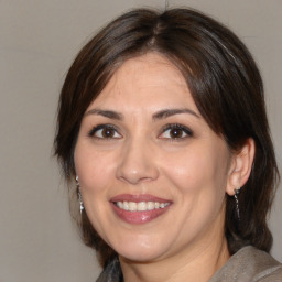 Joyful white adult female with medium  brown hair and brown eyes