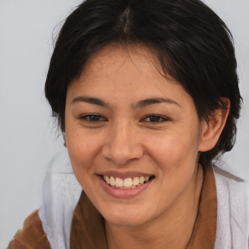 Joyful asian young-adult female with medium  brown hair and brown eyes