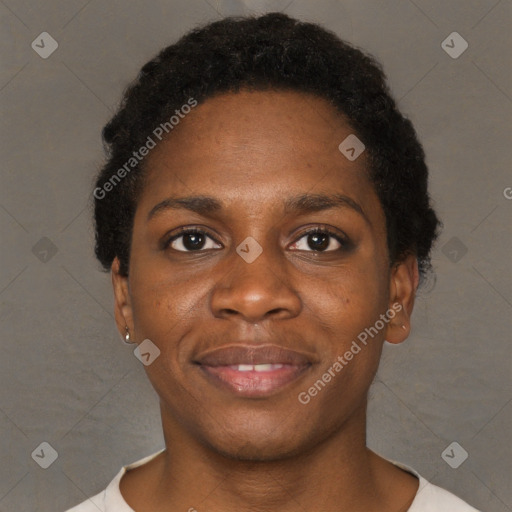 Joyful black young-adult female with short  black hair and brown eyes