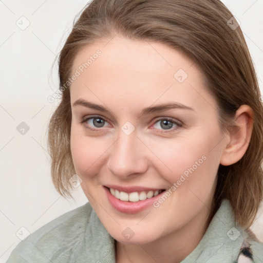 Joyful white young-adult female with medium  brown hair and blue eyes