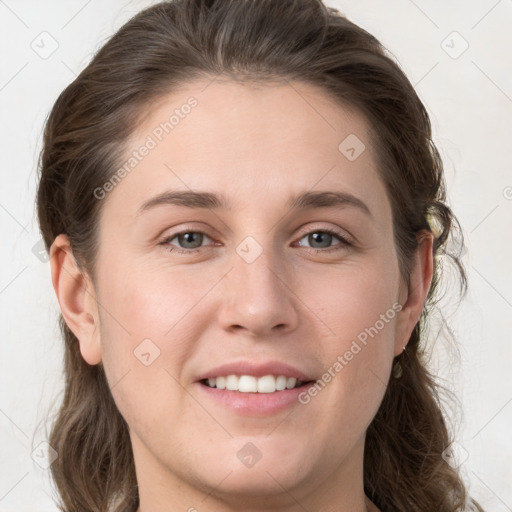 Joyful white young-adult female with long  brown hair and grey eyes