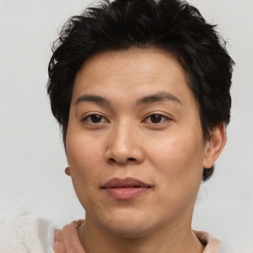 Joyful asian young-adult male with short  brown hair and brown eyes
