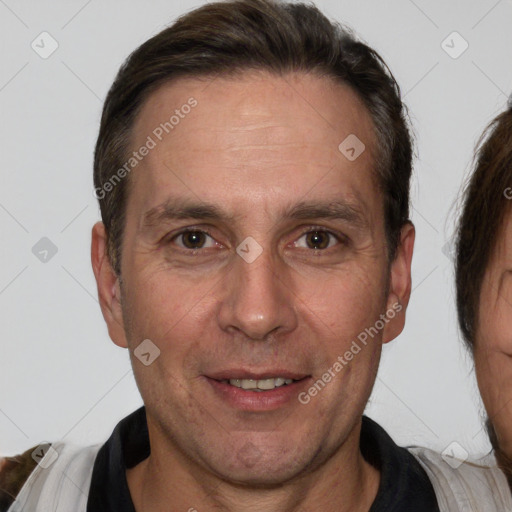 Joyful white adult male with short  brown hair and brown eyes