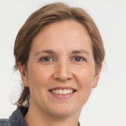 Joyful white adult female with medium  brown hair and grey eyes