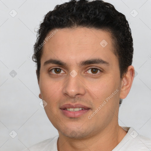 Joyful white young-adult male with short  black hair and brown eyes