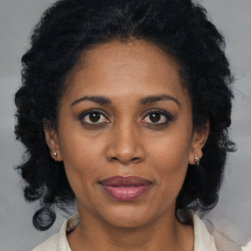 Joyful black young-adult female with medium  black hair and brown eyes