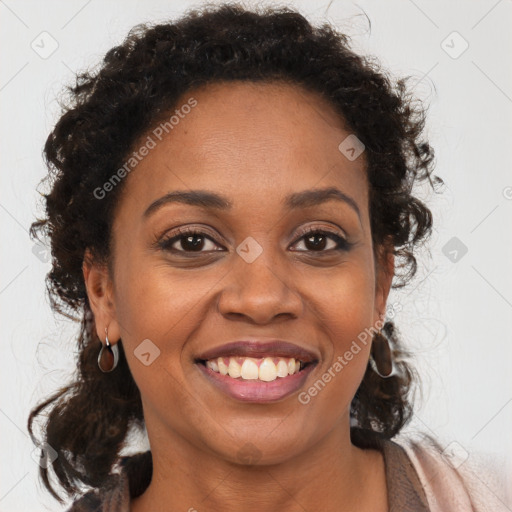 Joyful black young-adult female with long  brown hair and brown eyes