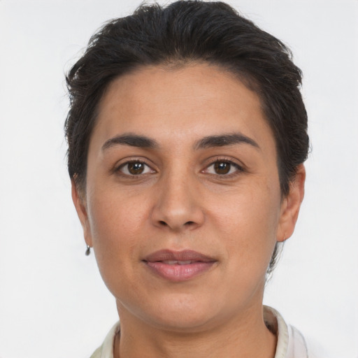 Joyful latino young-adult female with short  brown hair and brown eyes