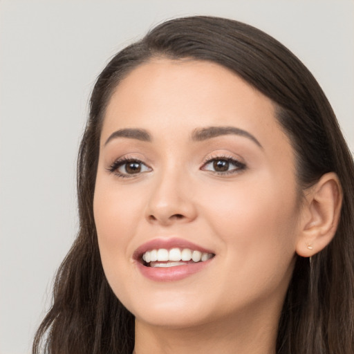 Joyful white young-adult female with long  brown hair and brown eyes